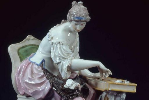 Porcelain woman playing the clavichord